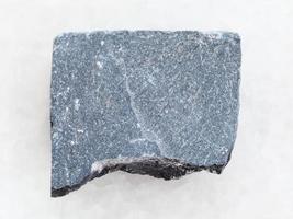 pedra de ardósia áspera em mármore branco foto