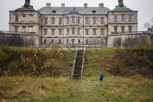 menino correndo, visite o castelo pidhirtsi, região de lviv, ucrânia. foto