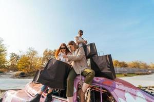 mulheres jovens posando no velho carro decorado foto