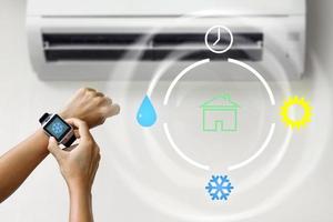 controle climático com um smartwatch. mulher usando ar condicionado foto