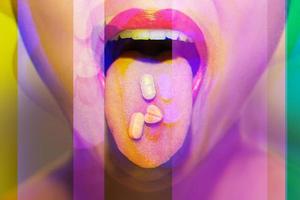 mulher com pílulas de drogas psicoativas na língua tendo uma viagem psicodélica com alucinações foto