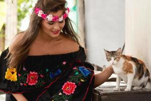 mulher jovem e feliz e gato de rua foto