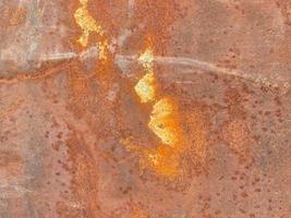 textura da superfície do velho gengibre arranhado enferrujado oxidado ferro ruim corroído metal. o fundo foto