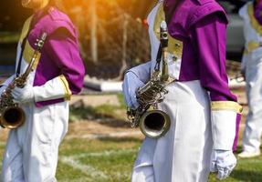 um saxofone está nas mãos dos alunos da orquestra da escola que jogam na competição esportiva da escola. foco suave e seletivo. foto