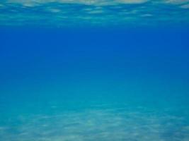 vista para o azul profundo com ondas suaves e reflexos foto
