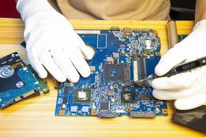 técnico reparando placa-mãe de computador, placa-mãe de notebook foto