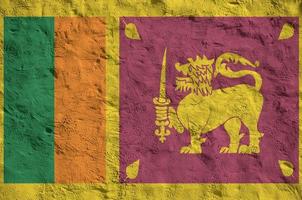 bandeira do sri lanka retratada em cores de tinta brilhantes na parede de reboco em relevo antigo. banner texturizado em fundo áspero foto