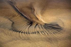 padrões na areia da praia foto