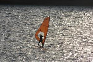 praticando windsurf no mar mediterrâneo, mar calmo foto