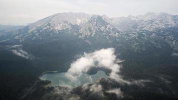 vista aérea do drone do lago negro no parque nacional durmitor em montenegro. área protegida da unesco. feriados e férias na natureza. floresta ao redor do lago. foto