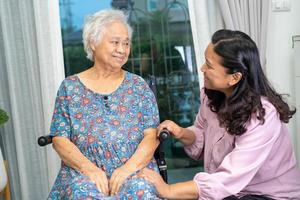 ajuda e cuidado paciente idoso asiático ou idosa senhora sentada em uma cadeira de rodas na enfermaria do hospital de enfermagem, conceito médico forte e saudável foto