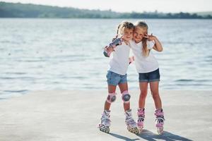 posando para uma câmera. amigas felizes em patins. tempo de lazer foto