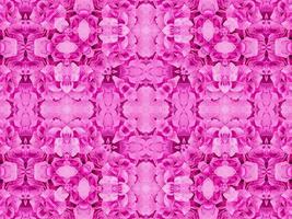 padrão de caleidoscópio floral magenta. fundo único e estético abstrato de flor rosa foto