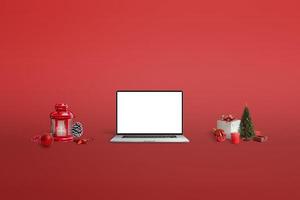 maquete de laptop em fundo vermelho cercado por decorações de natal foto