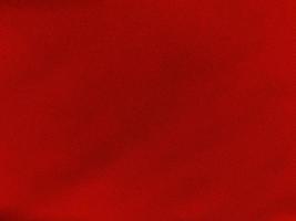 textura de tecido de algodão vermelho usada como plano de fundo. fundo de tecido vermelho vazio de material têxtil macio e liso. há espaço para o texto.. foto