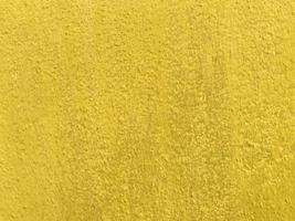 textura perfeita da velha parede de cimento amarelo uma superfície áspera, com espaço para texto, para um fundo. foto