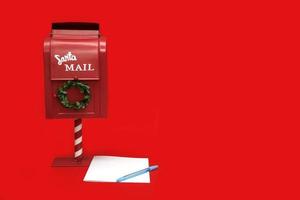 caixa de correio do papai noel com papel em branco e caneta sobre fundo vermelho com espaço de cópia foto