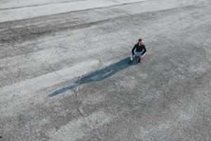 visão superior do homem sentado na estrada à noite sozinho foto