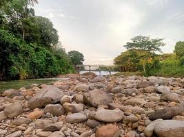 belas paisagens naturais no céu azul, nuvens brancas e muitas árvores verdes ao seu redor foto