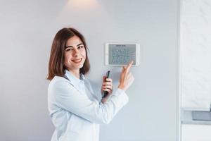 mulher está dentro de casa controlando tecnologia de casa inteligente foto