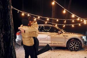 dando um passeio. casal dançando na floresta e comemorando o ano novo foto