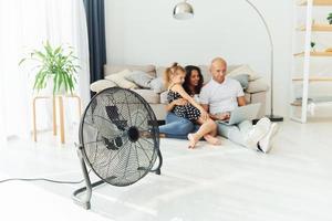 sentado no chão. casal alegre está junto dentro de casa foto