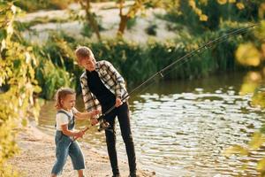 se divertindo. menino com sua irmã na pesca ao ar livre no verão juntos foto