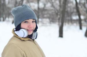 retrato de inverno de jovem com fones de ouvido foto