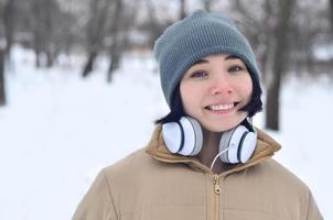 retrato de inverno de jovem com fones de ouvido foto