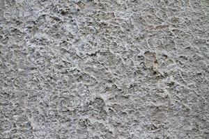 visão detalhada em paredes de concreto envelhecidas com rachaduras e muita estrutura em alta resolução foto