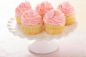 cupcakes de baunilha com cobertura de framboesa rosa foto