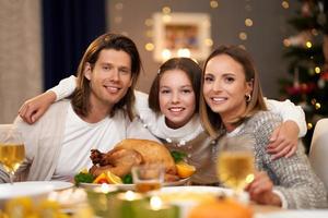 linda família comendo o jantar de natal em casa foto