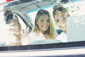 mulheres jovens viajando de carro com mapa foto