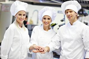 chefs ocupados trabalhando na cozinha do restaurante foto