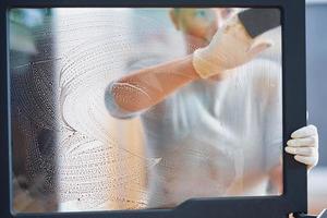 foto de jovem limpando as portas de vidro da lareira