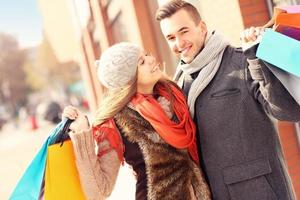 casal feliz fazendo compras na cidade foto