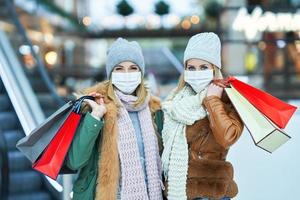 retrato de dois amigos fazendo compras juntos usando uma máscara, conceito de coronavírus foto