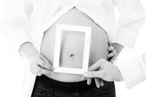 conceito de sorriso de bebê. moldura na barriga de grávida foto