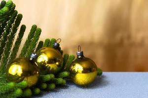 linda decoração de natal com galhos de pinheiro fundo dourado e esferas foto