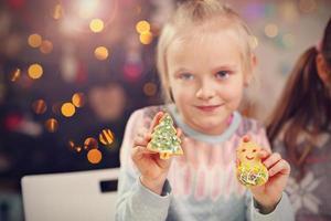 irmãzinhas felizes preparando biscoitos de natal foto