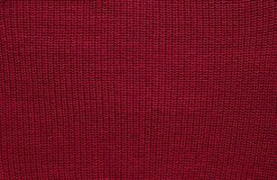 textura de suéter de malha lisa com padrão. lã de tricô artesanal ou textura de tecido de algodão. fundo de padrão de malha grande com agulha de tricô ou crochê. cor do ano 2023 - viva magenta foto