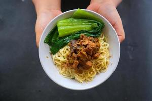 mie ayam ou noodles frango é comida tradicional da indonésia, ásia feita de macarrão, frango, caldo de galinha, espinafre, às vezes com almôndega. foto