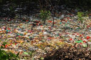 lixo plástico derramado na terra da cidade grande. garrafas plásticas sujas usadas vazias. poluição plástica. poluição ambiental. problema ecológico. foto