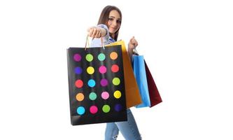 conceito de compras. bela morena sorridente com sacolas de compras posando em fundo branco foto