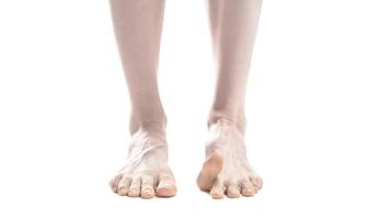 pés descalços da mulher bonita contra um fundo branco. foto