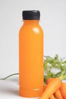 suco de cenoura em uma garrafa de plástico transparente. bebida saudável. foto