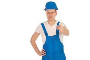 Construtor jovem sério de uniforme azul foto