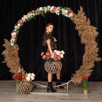 linda mulher posando no círculo de madeira morta em vestido com estampa de flores foto