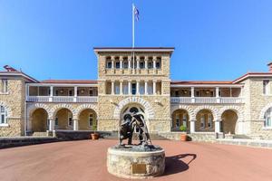 perth mint building, uma das três filiais da casa da moeda real australiana. edifício de pedra calcária construído em 1899. fachada com uma estátua de garimpeiros extraindo ouro. foto