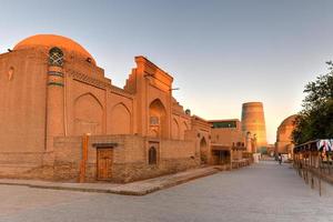 minarete menor de kalta e a arquitetura histórica de itchan kala, cidade murada do interior da cidade de khiva, uzbequistão, um patrimônio mundial da unesco. foto